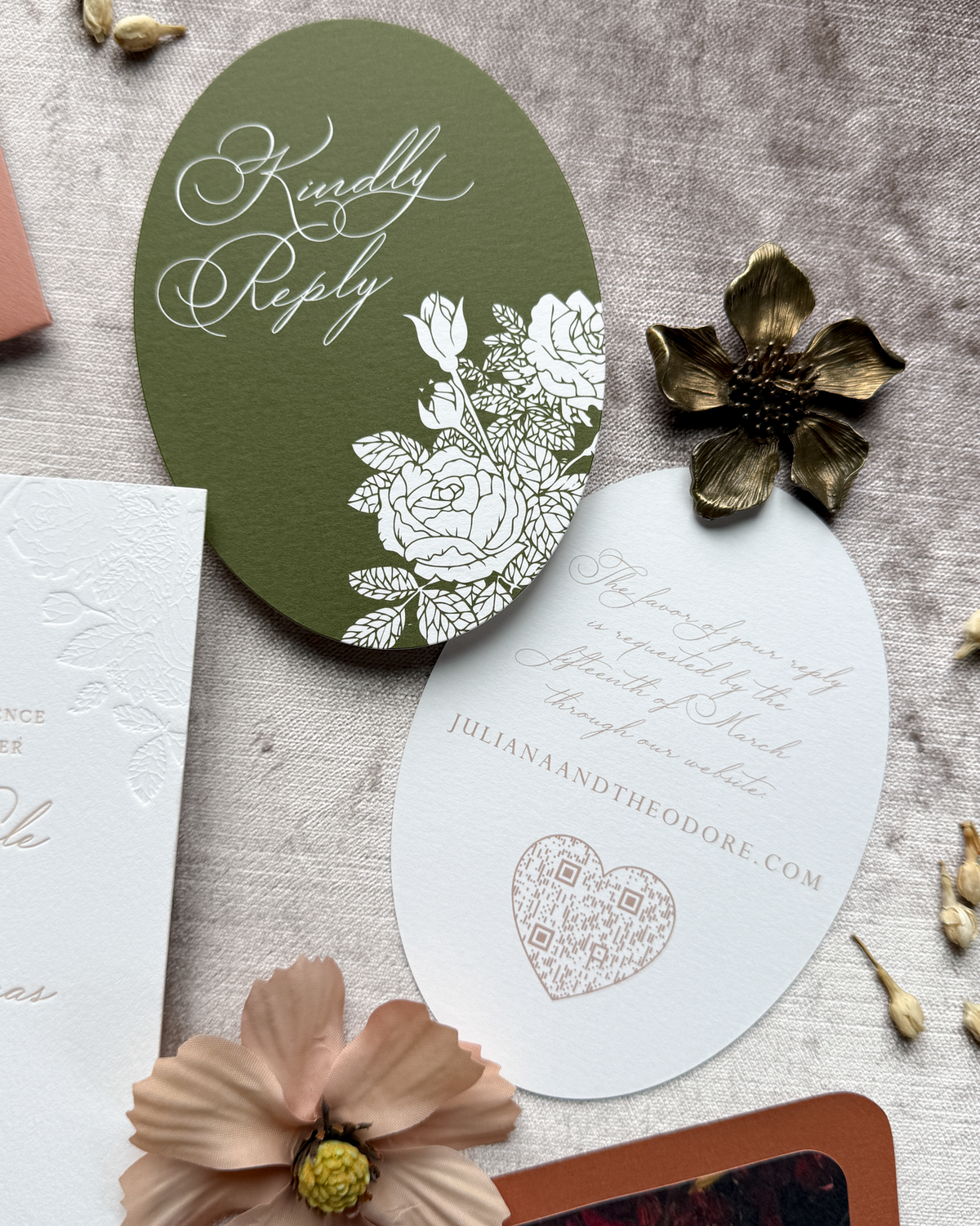 Invitation card with floral design and text on a textured surface with flowers.