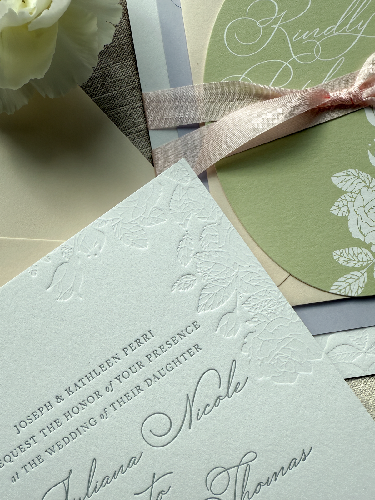 Wedding invitation card featuring debossed detail