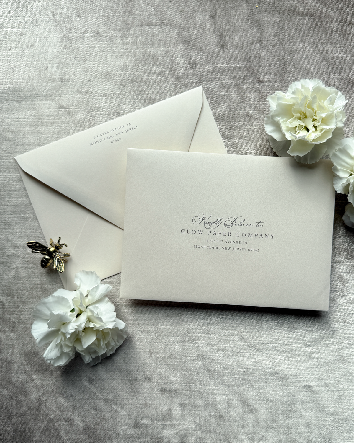 Blush envelopes on a gray surface