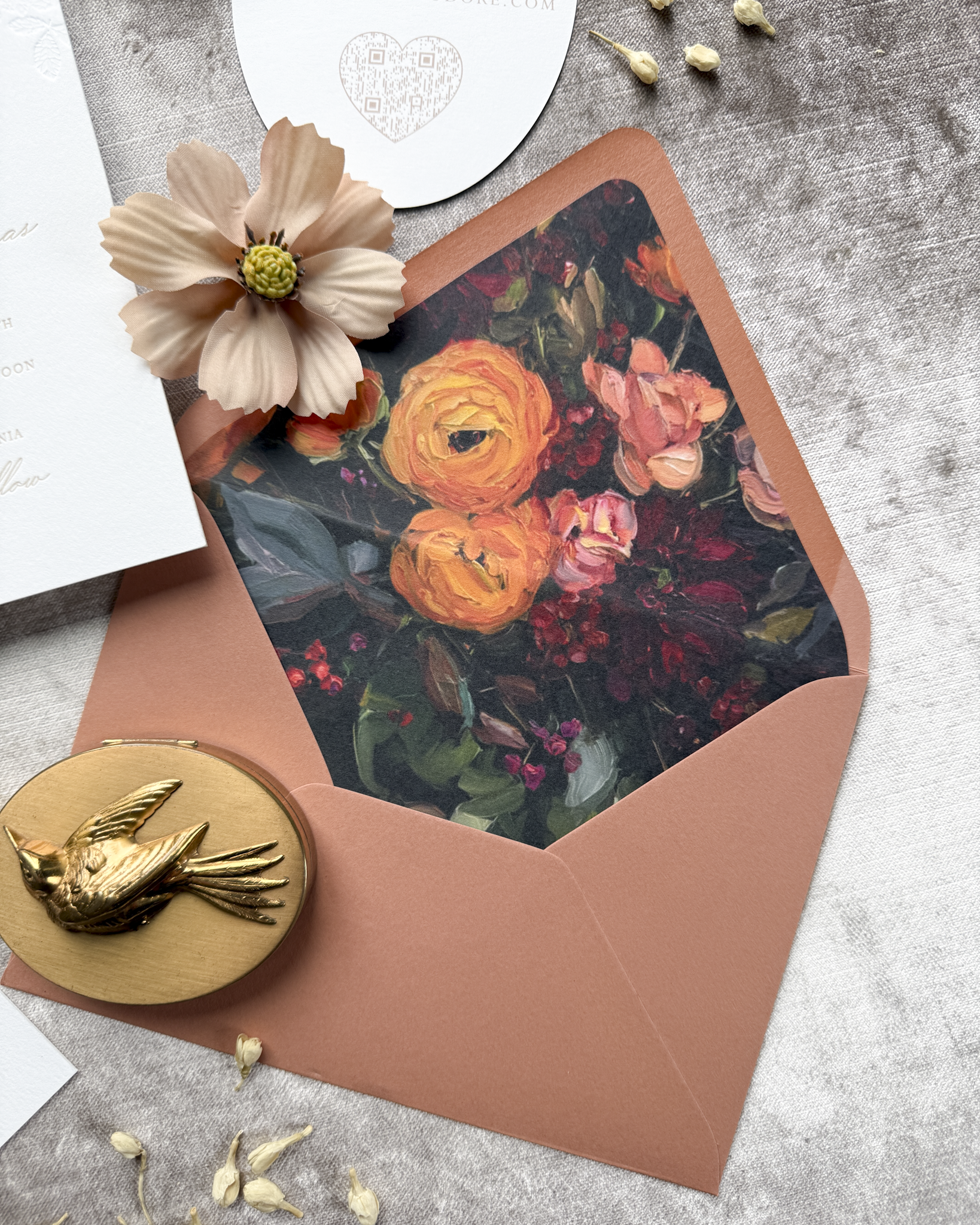 Floral envelope with a decorative liner on a textured surface