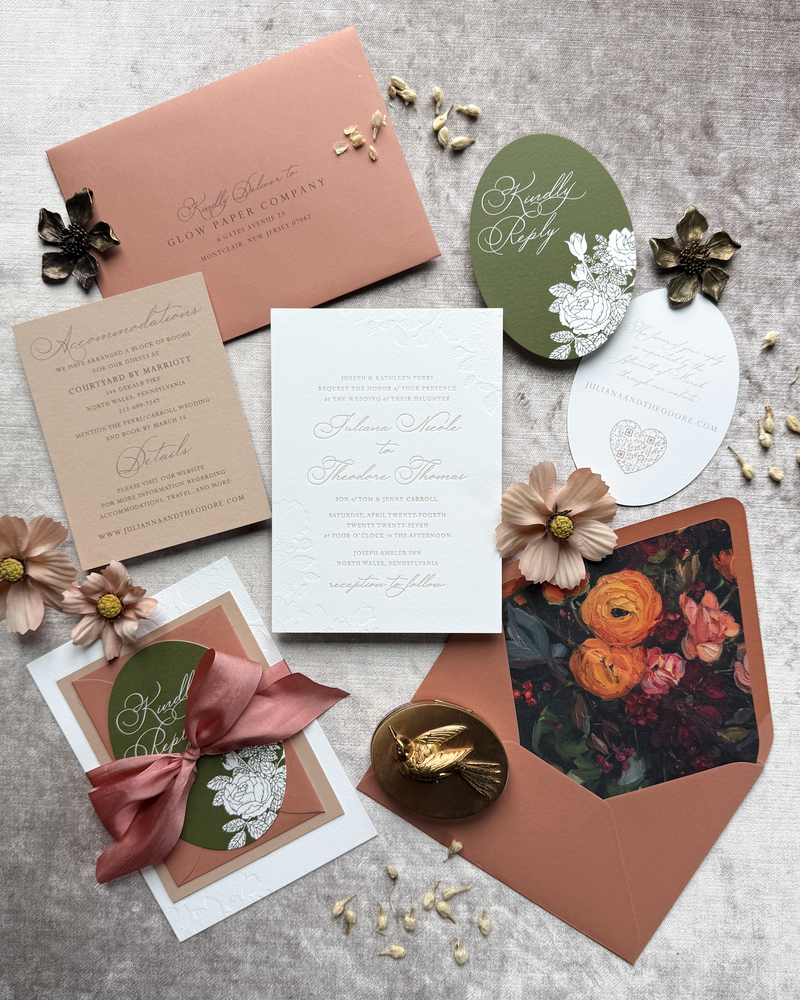 An autumn wedding invitation in warm fall colors, featuring a die cut insert and a floral envelope liner