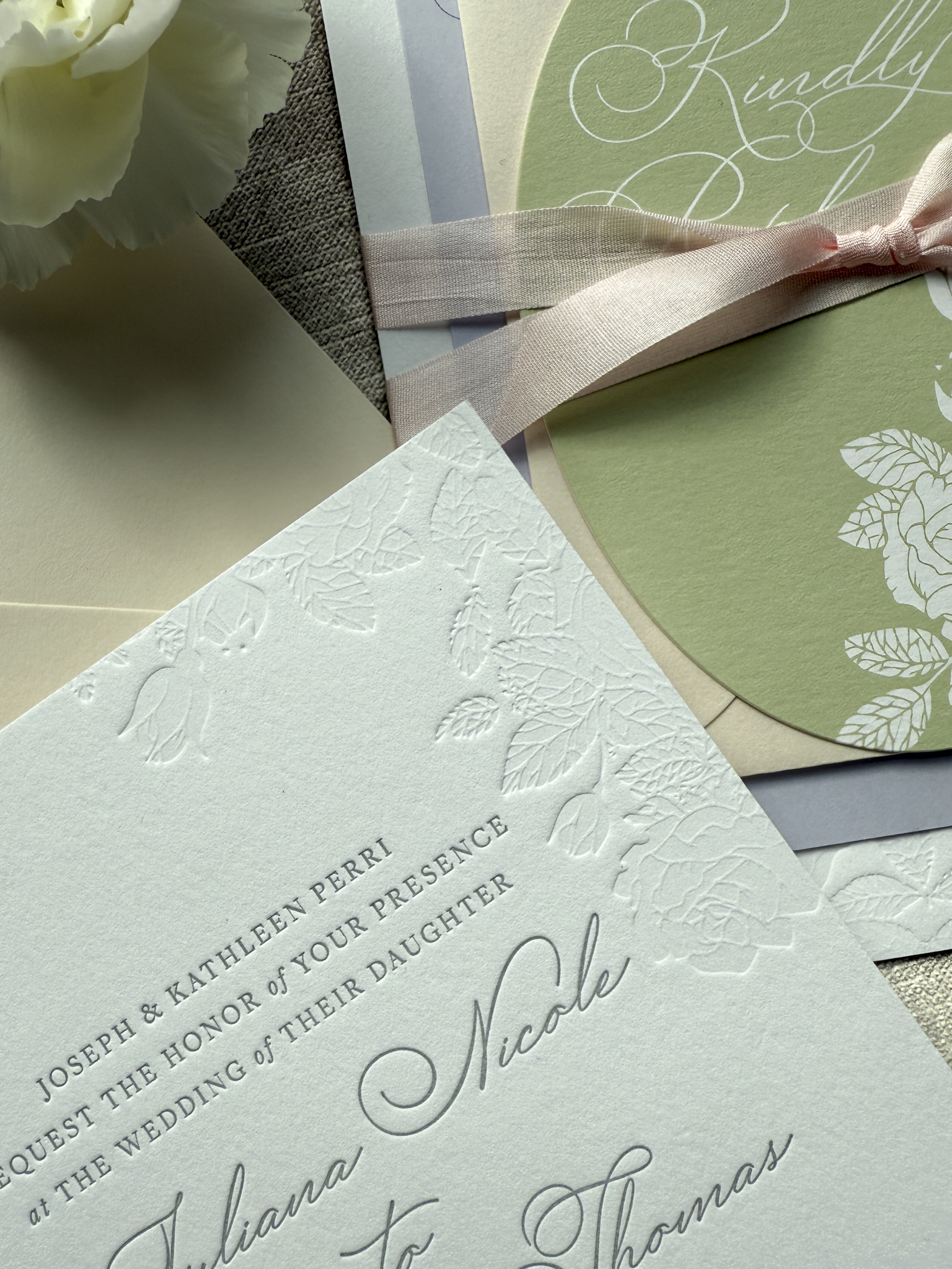 Wedding invitation card featuring debossed detail