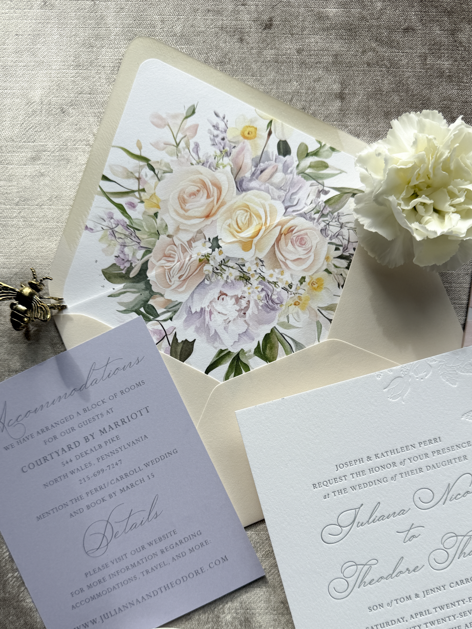 Wedding invitation envelope with floral design on a textured surface