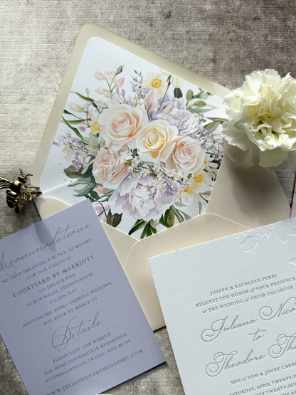 Wedding invitation envelope with floral design on a textured surface