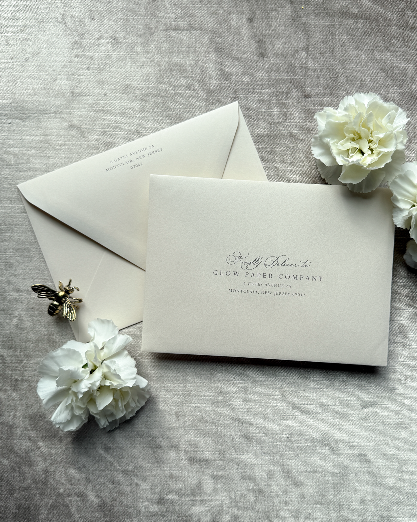 Blush envelopes on a gray surface