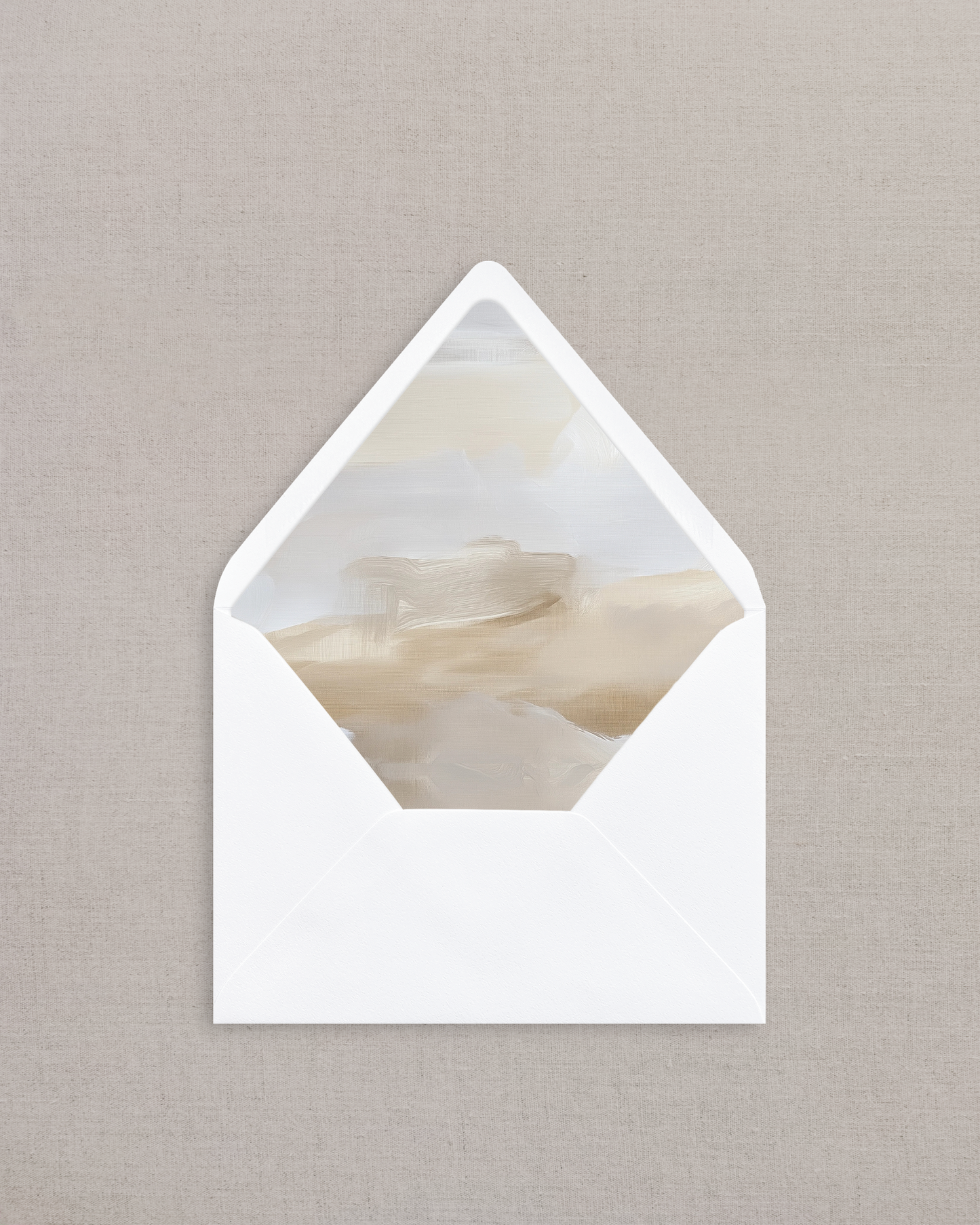 White envelope with a marble-patterned interior on a beige background