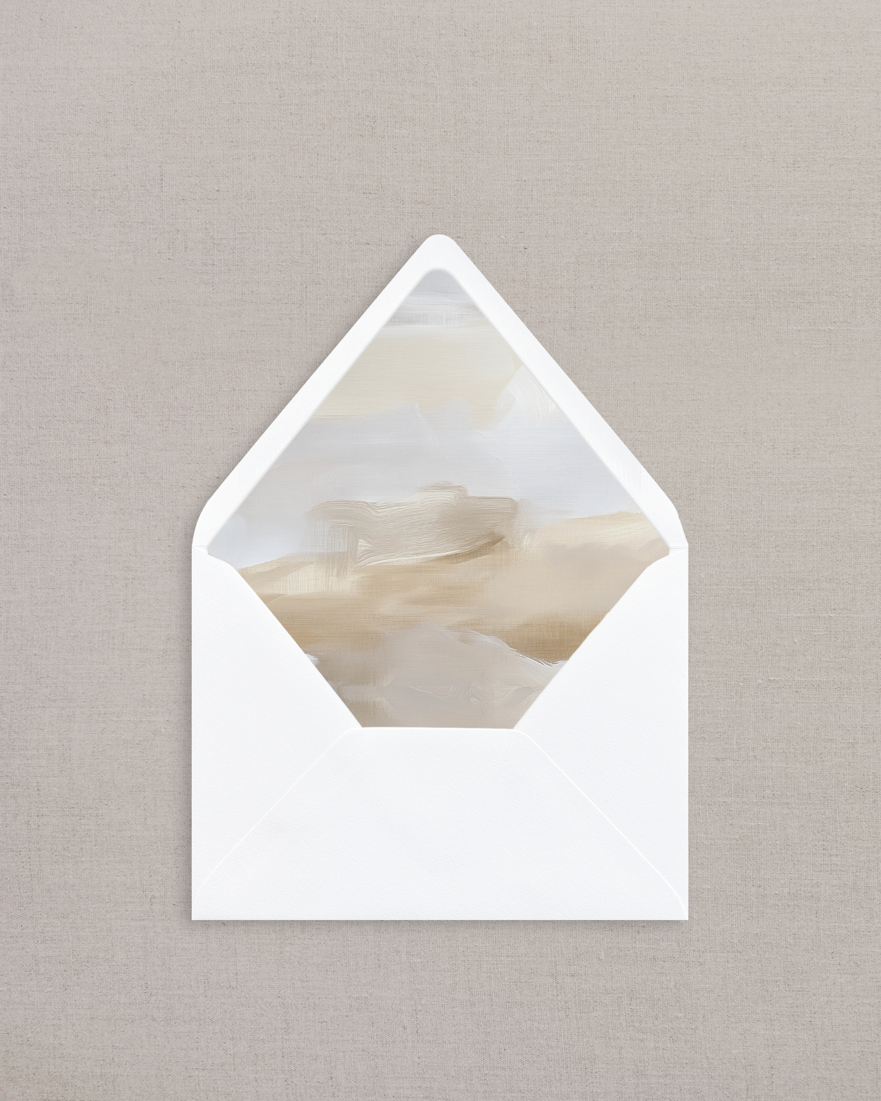 White envelope with a marble-patterned interior on a beige background