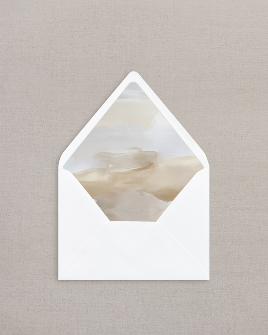White envelope with a marble-patterned interior on a beige background