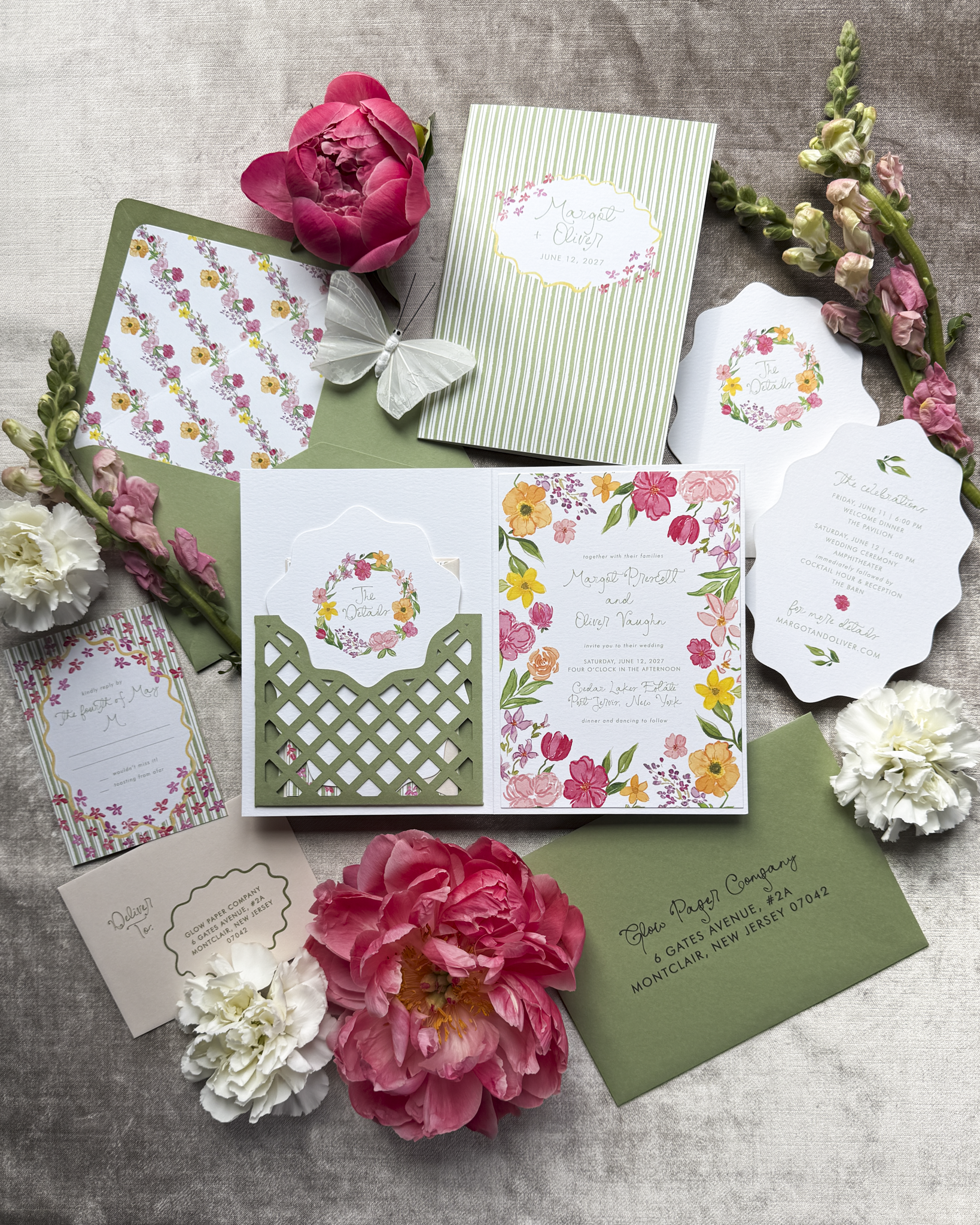 A wedding invitation suite featuring bold watercolor florals, and a laser cut pocket, in bright colors with a focus on green
