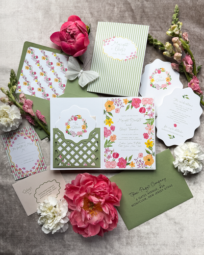 A wedding invitation suite featuring bold watercolor florals, and a laser cut pocket, in bright colors with a focus on green