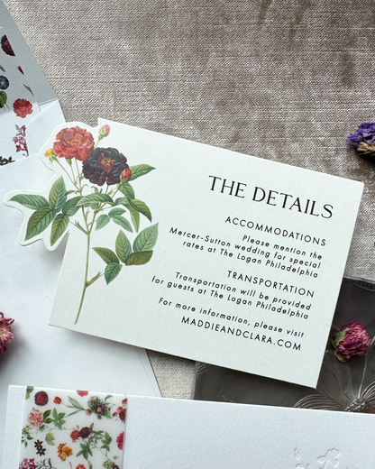 Wedding detail card with floral design on a textured surface