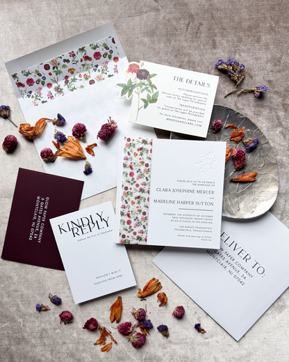 Stationery items including cards and envelopes with dried flowers on a textured surface