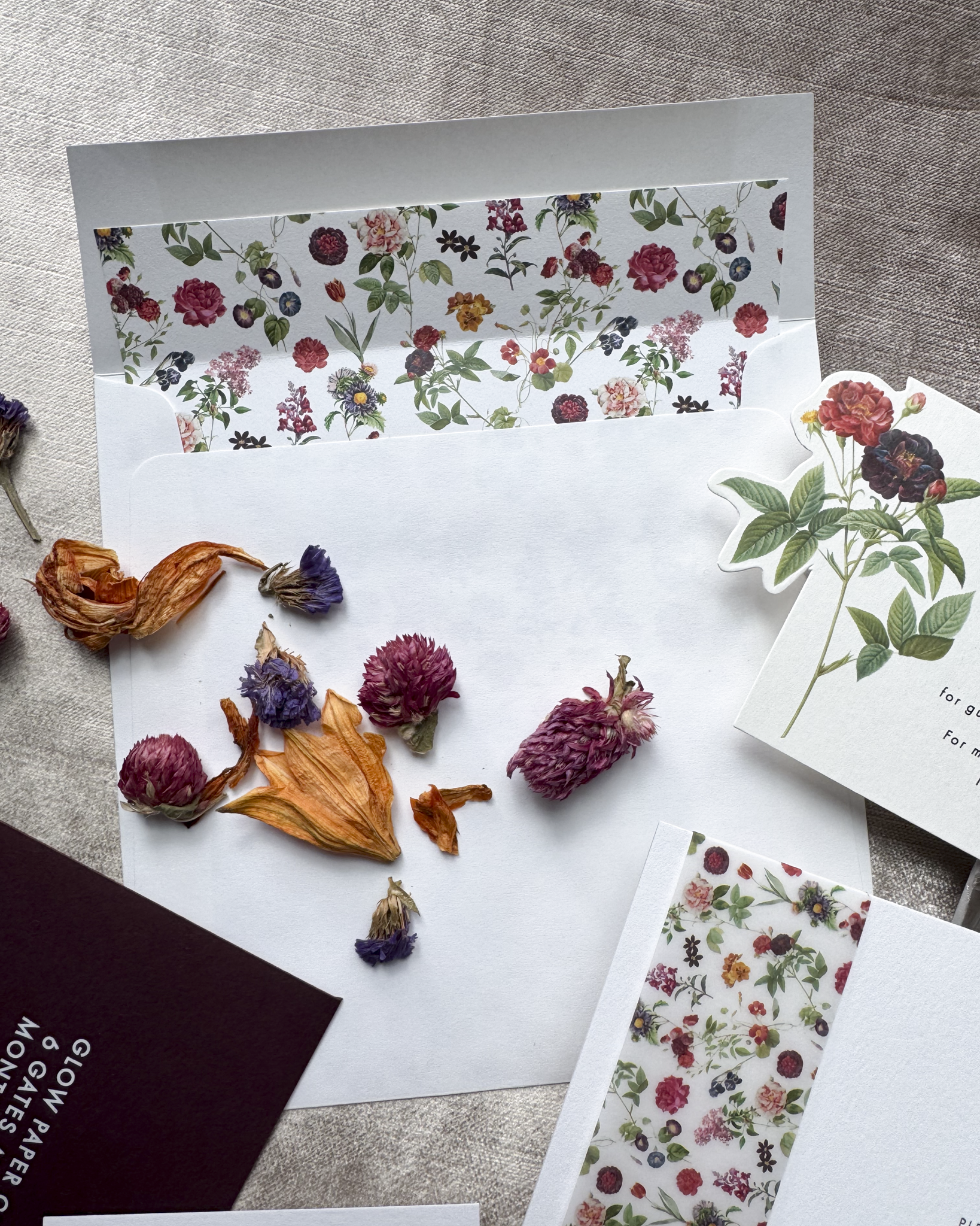 Floral stationery set with dried flowers on a textured surface