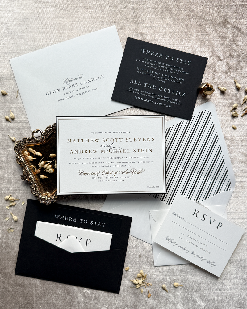 A stately black and gold wedding invitation featuring a back pocket and pinstripe liner